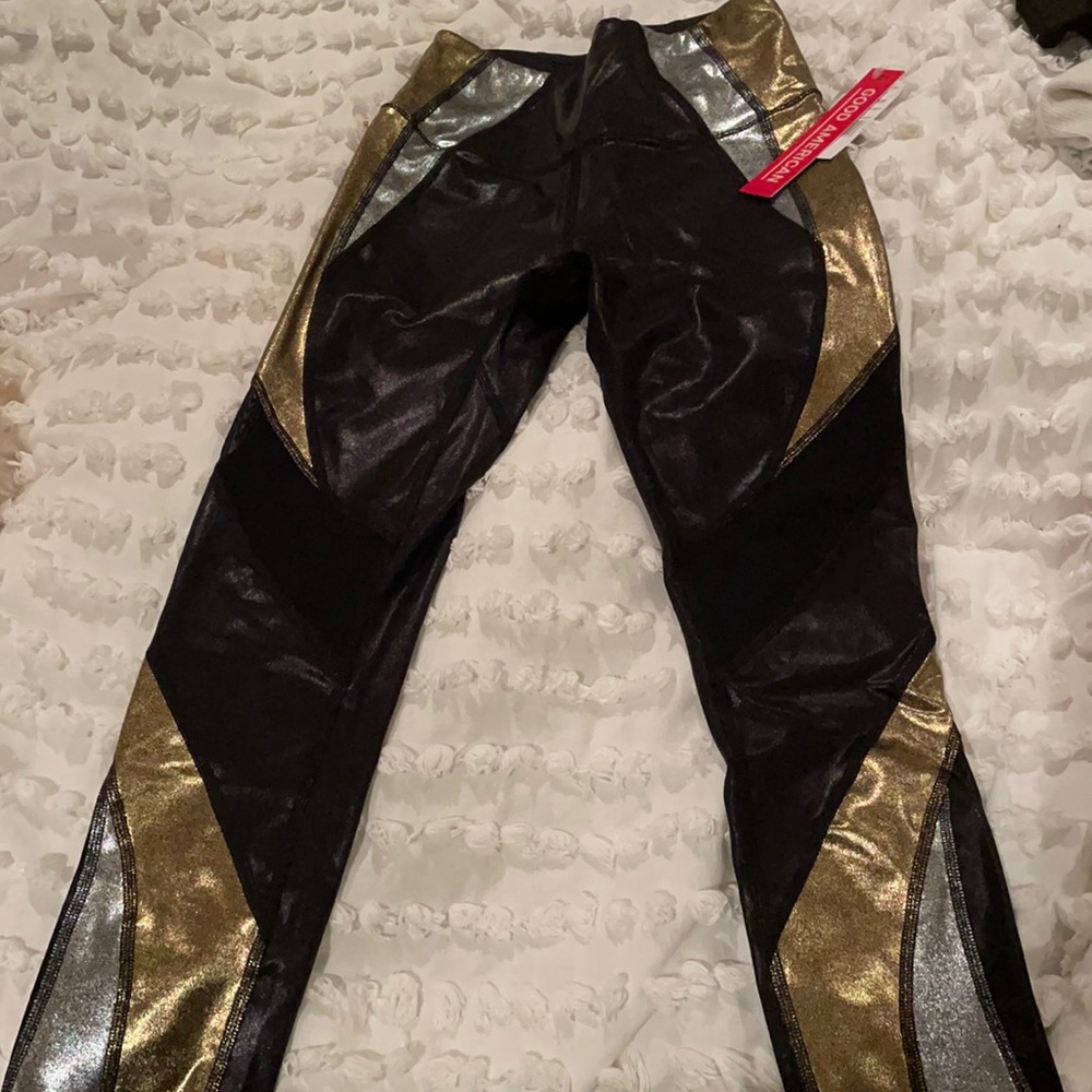 Good American silver gold black shiny mesh leggings.